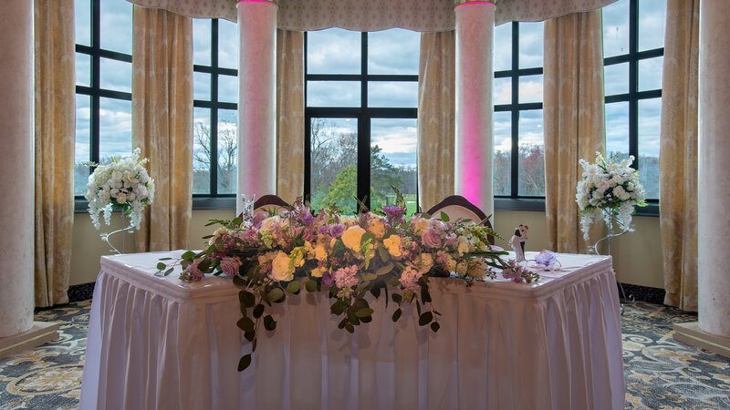 Flower decoration on table set for two with view of outside