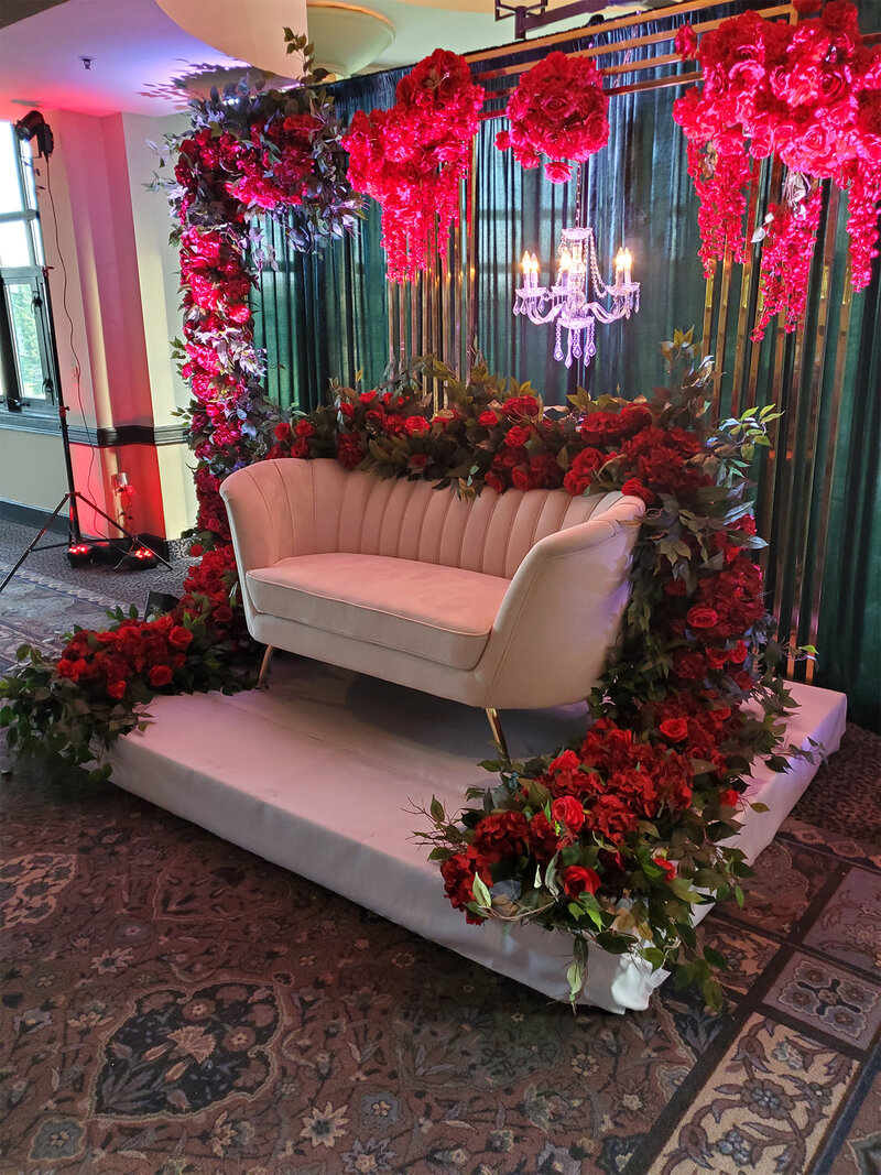 Sofa with red flower decorations and chandelier