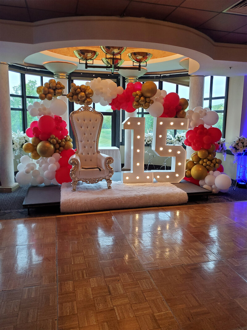 Private event room with chair, balloon decorations and large 15 sign