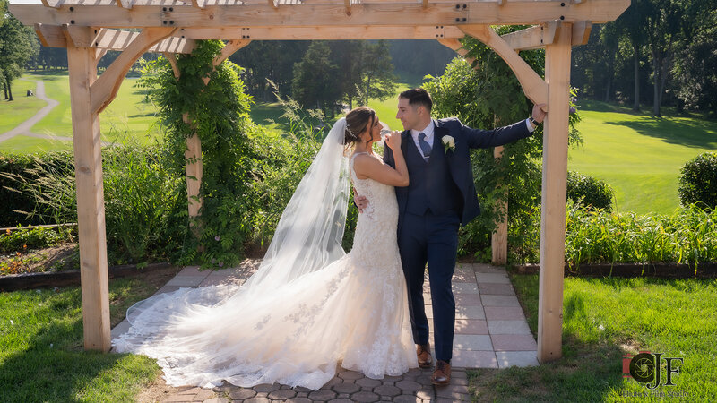 Bride and groom outside looking at each other