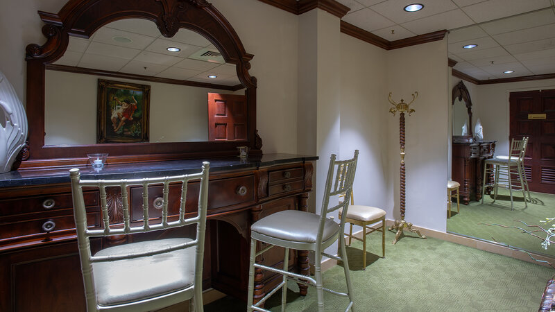 Dressing room with vanity and chairs