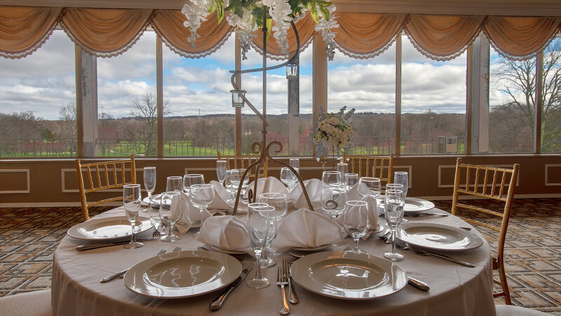 Round table set for eight guests with flower decoration