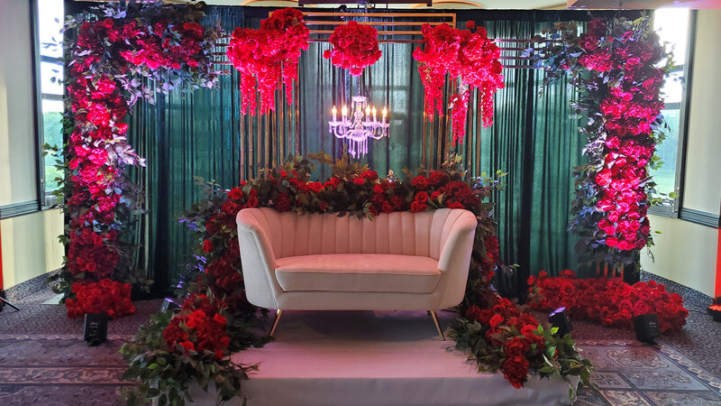 Couch on platform with lots of rose flower decorations