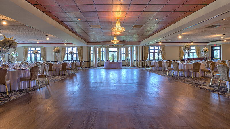 Party room with many set tables and dance floor