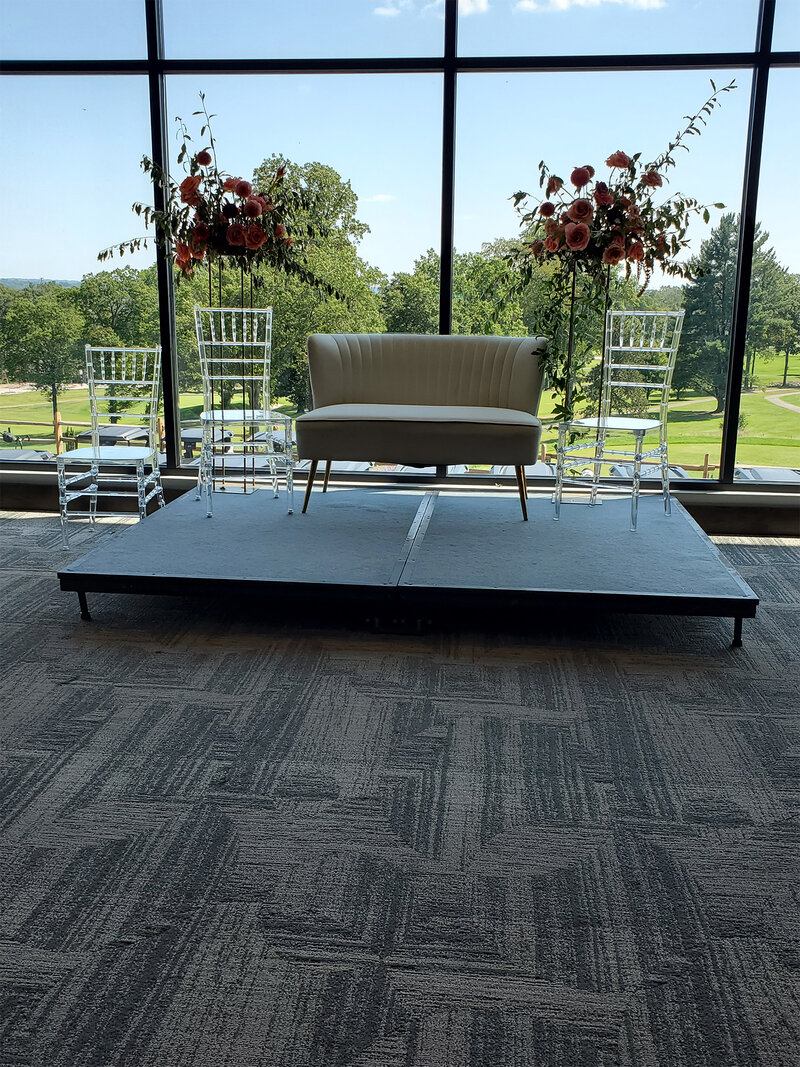 Couch and chairs on platform in private event room