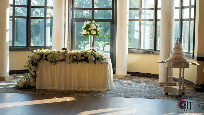 Room with decorated table and wedding cake