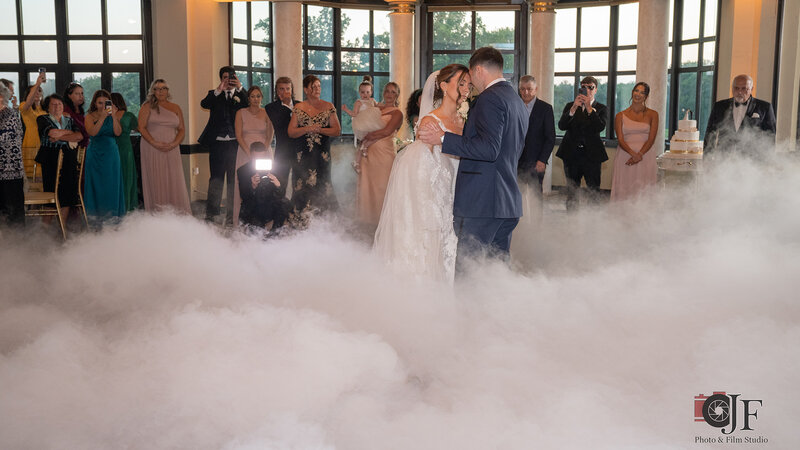 Bride and groom dancing with fog machine