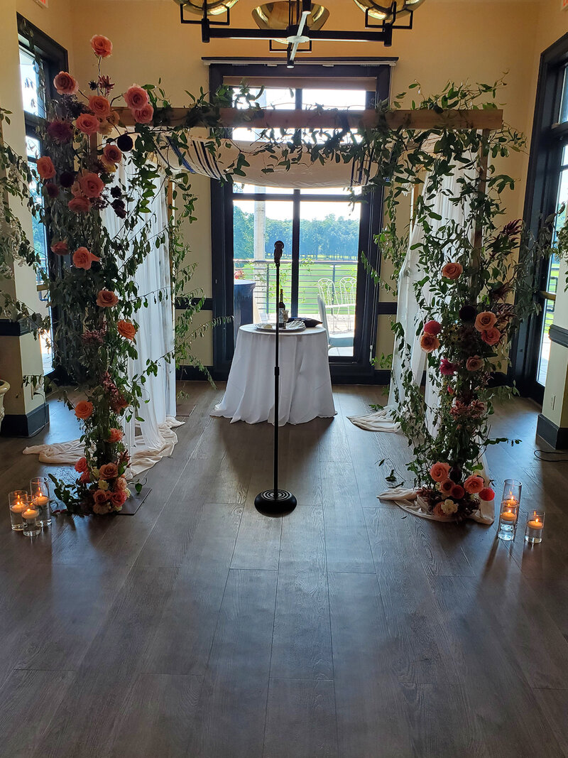 Altar decorated with flowers and microphone stand